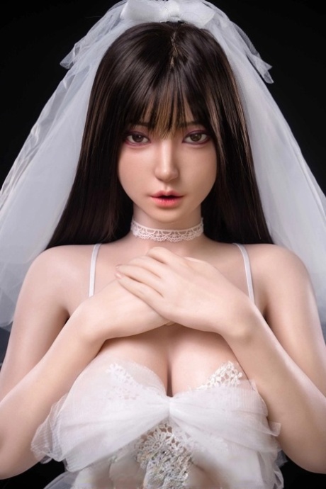 Pretty sex doll shows her petite body in a sexy wedding dress & while naked