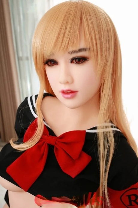 Attractive Asian sex doll Jelka posing in her hot schoolgirl outfit in a solo