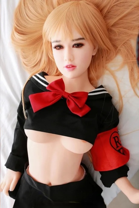 Attractive Asian sex doll Jelka posing in her hot schoolgirl outfit in a solo