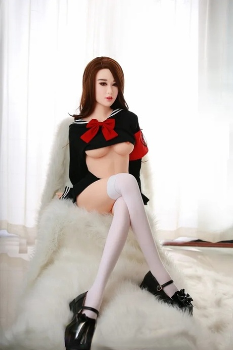 Attractive Asian sex doll Jelka posing in her hot schoolgirl outfit in a solo