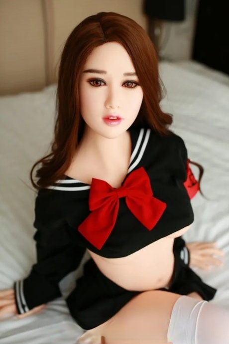 Attractive Asian sex doll Jelka posing in her hot schoolgirl outfit in a solo