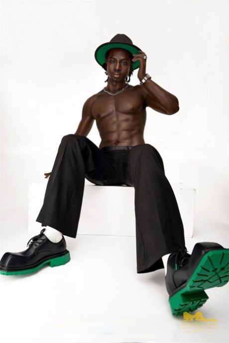 Good-looking black male sex doll shows his athletic body while shirtless