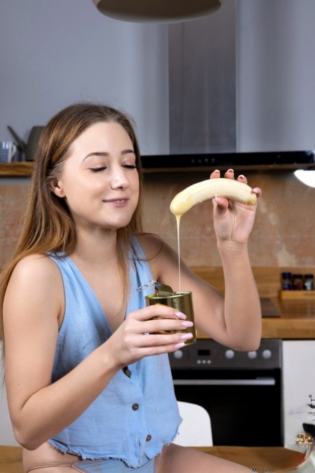 European teen Mila Minx eats a banana before stripping and masturbating