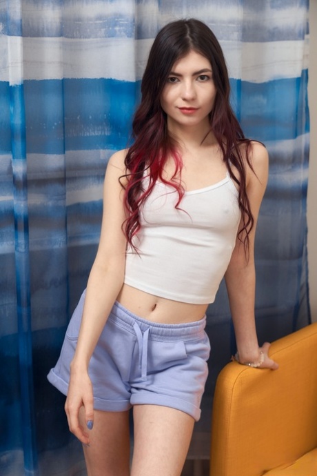 Pretty brunette teen Luna Lynx plays with her shaved pussy on her bed