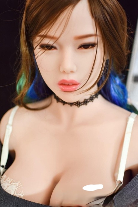 Asian silicone sex doll Veronica undresses and teases with her big juggs