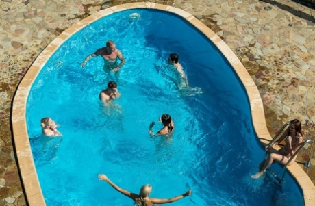 Playful European teens sucking and fucking rock-hard dicks in a poolside orgy