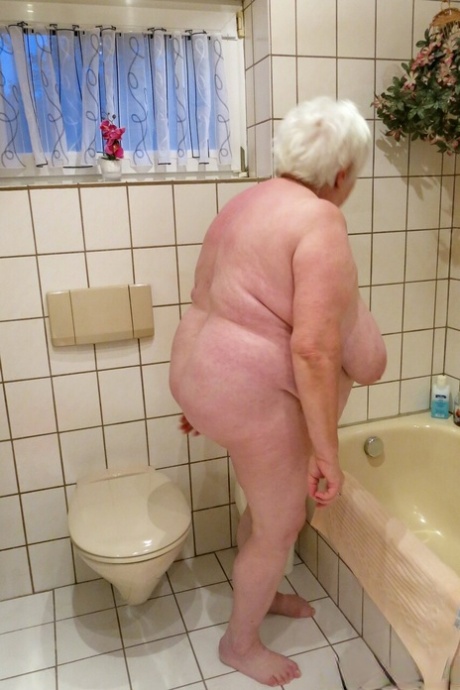 Naughty granny Neebana shows her chubby body while completely naked