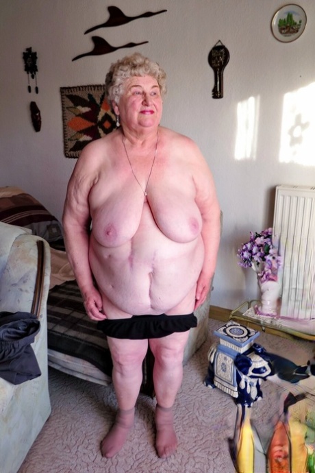 Fat old granny Siberia lets out her saggy tits and poses naked at her home