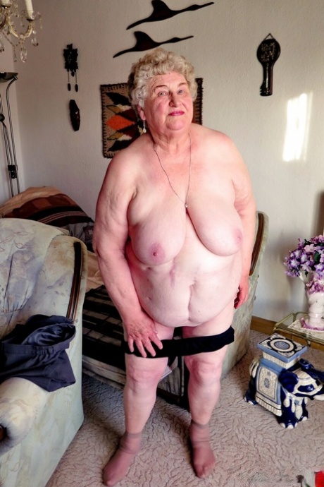 Fat old granny Siberia lets out her saggy tits and poses naked at her home