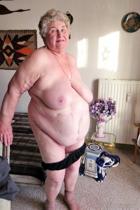 Fat old granny Siberia lets out her saggy tits and poses naked at her home