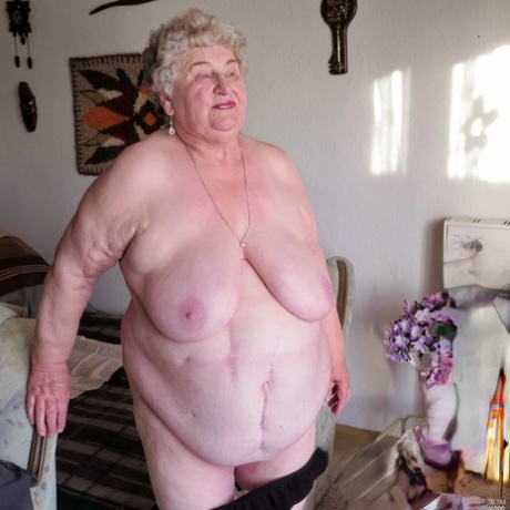 Fat old granny Siberia lets out her saggy tits and poses naked at her home