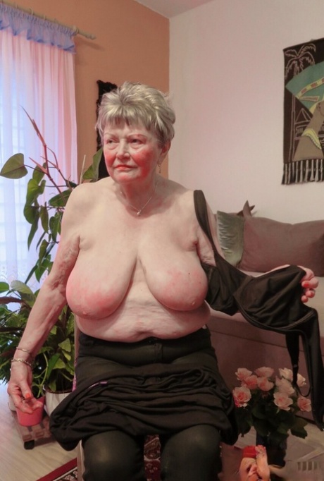 Kinky old granny Phyladelphia doffs her clothes and lets out her huge breasts