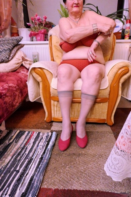 Naughty granny Prolet shows off her saggy tits while undressing
