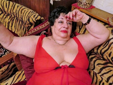 Playful short-haired granny Hormonaria shows her saggy tits while changing