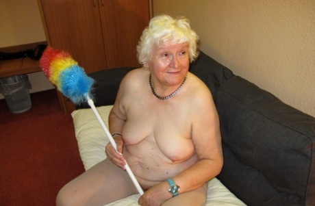 Fat blonde granny Puma poses naked wearing cop hat and sunglasses