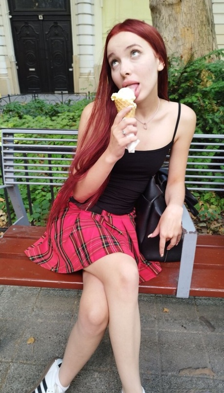 Pale redhead Megan Murkovski eats an ice cream cone before having sex on a bed