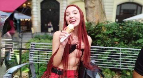 Pale redhead Megan Murkovski eats an ice cream cone before having sex on a bed