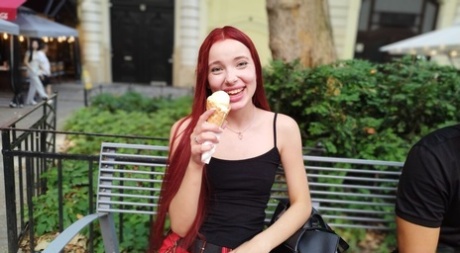 Pale redhead Megan Murkovski eats an ice cream cone before having sex on a bed