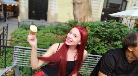 Pale redhead Megan Murkovski eats an ice cream cone before having sex on a bed