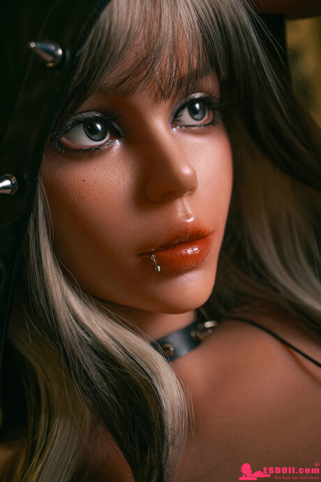 Sex doll with striking eyes and a lip piercing unveils her hot body