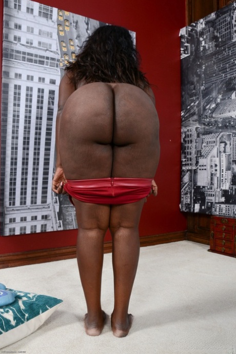 Ebony with natural tits Black Dahlia strips and flaunts her huge ass and twat