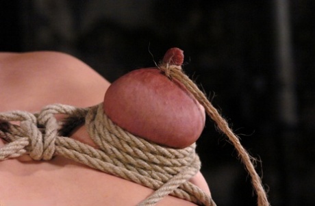 Kinky babe LieLani gets her big nips rope tied and tugged hard on a BDSM wheel